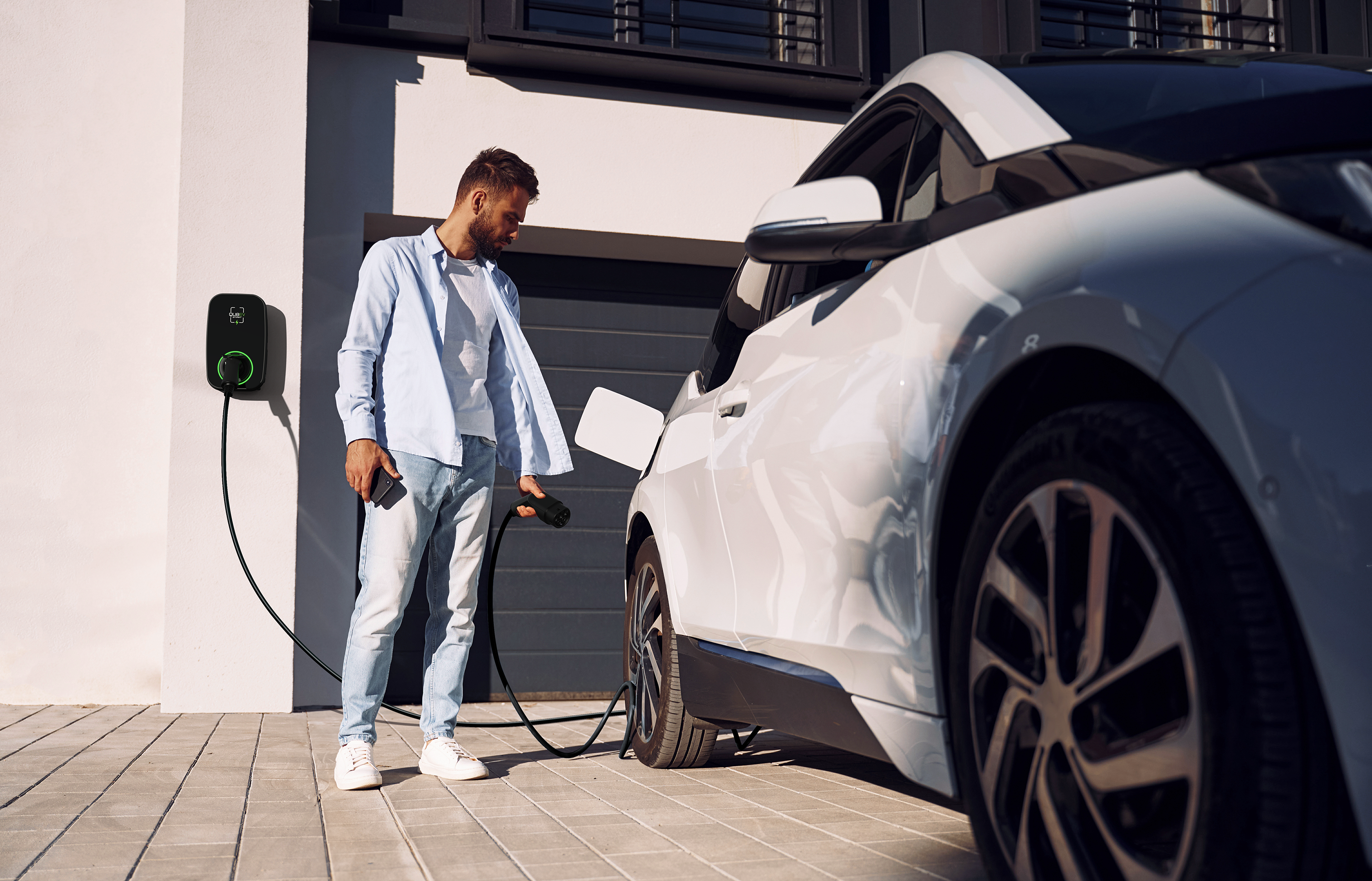 A man preparing to charge his car